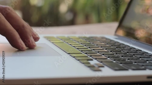 Closeup of business man hand typing on laptop keyboard