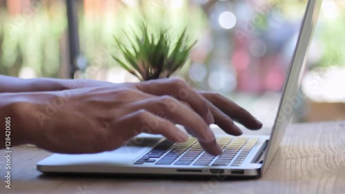 Closeup of business man hand typing on laptop keyboard