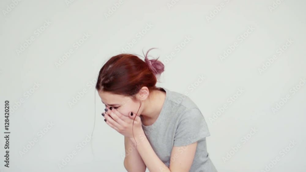 Portrait sad girl teenager 14 years old sneezes and looking at camera on white background. Slow motion from Sony A6300 Portrait sad girl teenager 14 years old sneezes and looking at camera on white background. Slow motion from Sony A6300