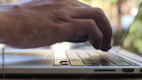 Closeup of business man hand typing on laptop keyboard