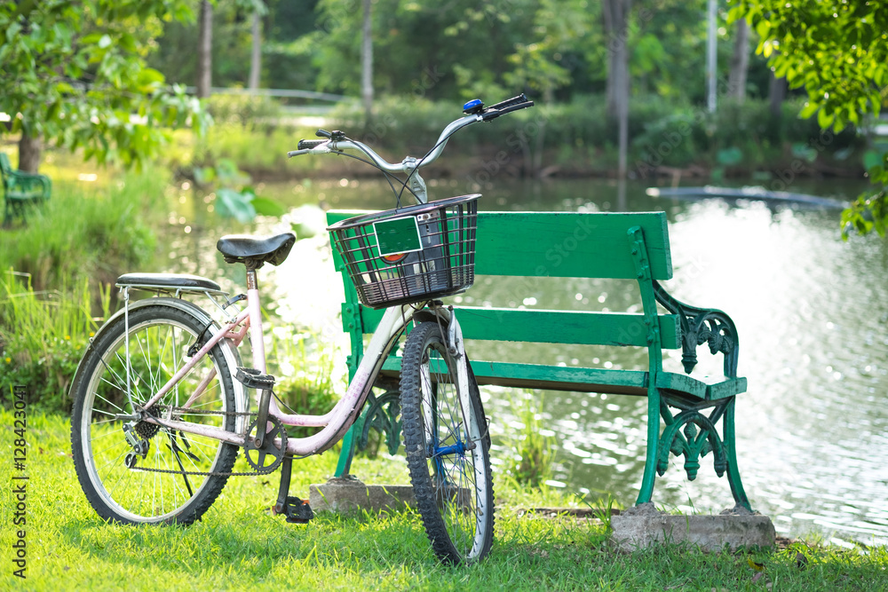 bicycle and bench at  riverside in park