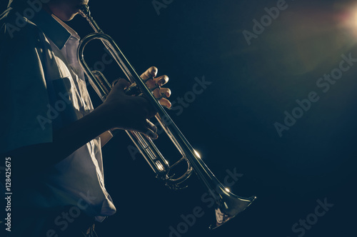 Photography Young student Musician playing the Trumpet with spot light and l