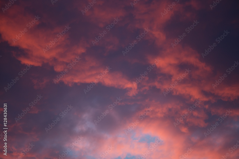 Dramatic and moody pink, purple, blue cloudy sunset sky