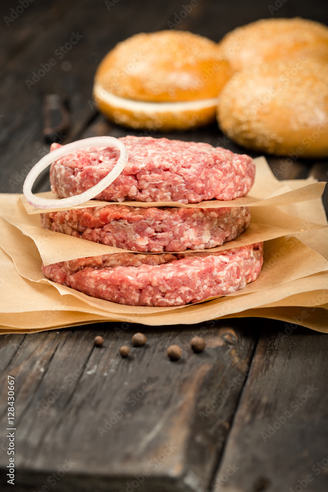 Raw ground beef meat cutlets and buns for burger Raw ground beef meat cutlets and buns for burger