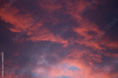 Dramatic and moody pink, purple, blue cloudy sunset sky