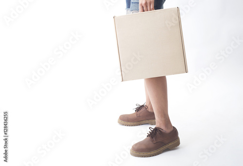 women legs in leather boots fashion and hand holding paper box side view isolated on the white background.