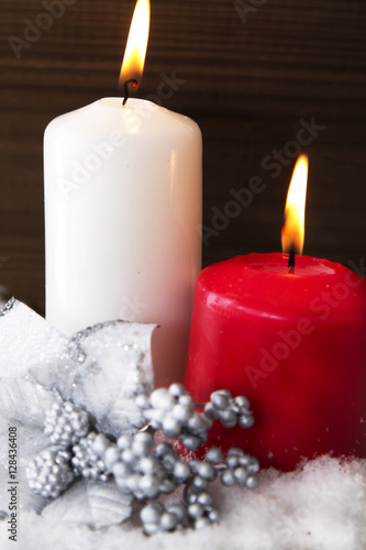Christmas card with candles and Christmas decorations in the snow