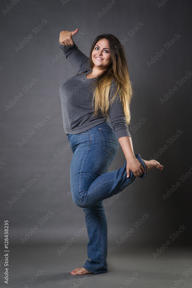 Hick sympathie Grijp Young beautiful plus size model in blue jeans, xxl woman on gray studio  background Stock Photo | Adobe Stock