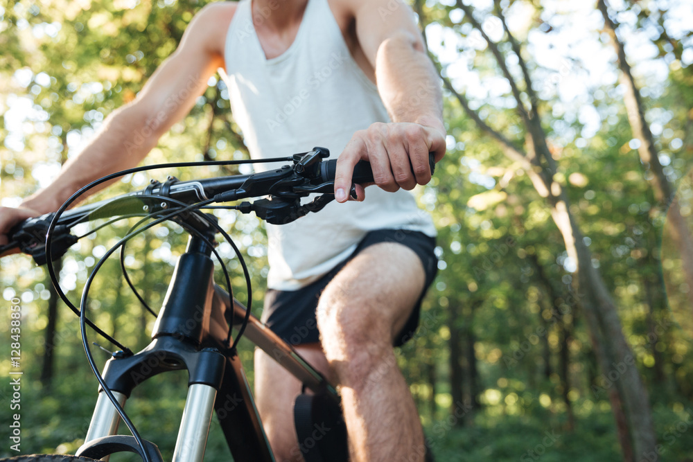 Naklejka premium Cropped cyclist in forest
