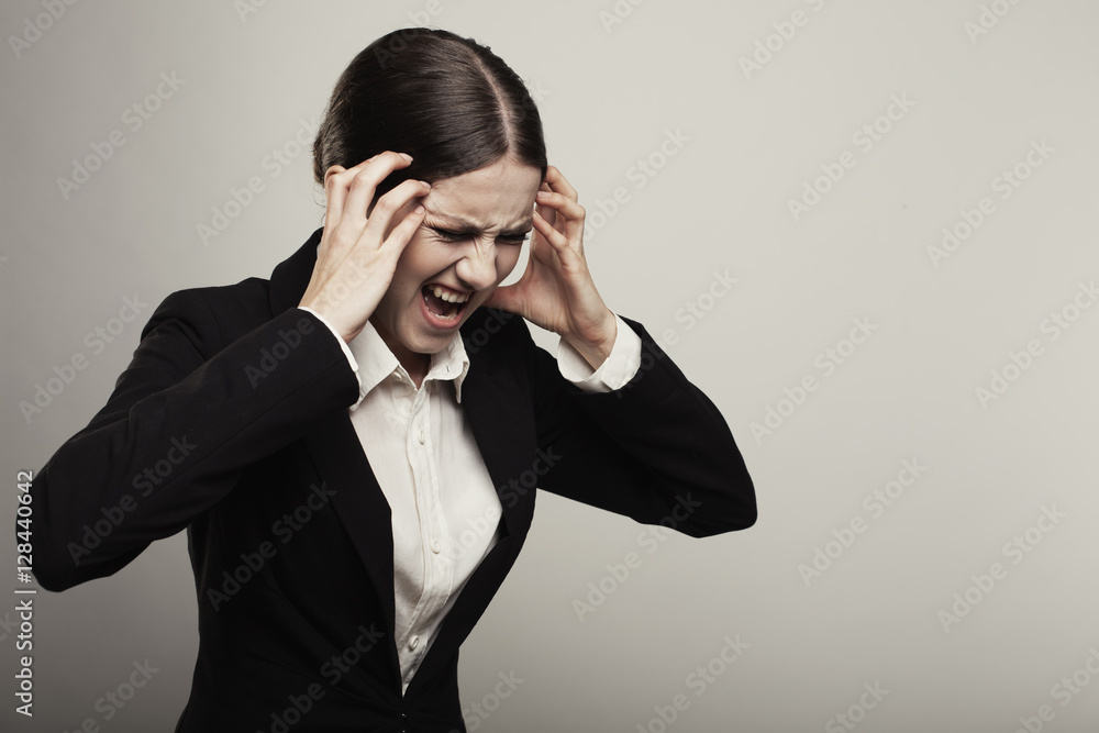 Young business woman suffering head pain or migraine isolated on Young business woman suffering head pain or migraine isolated on