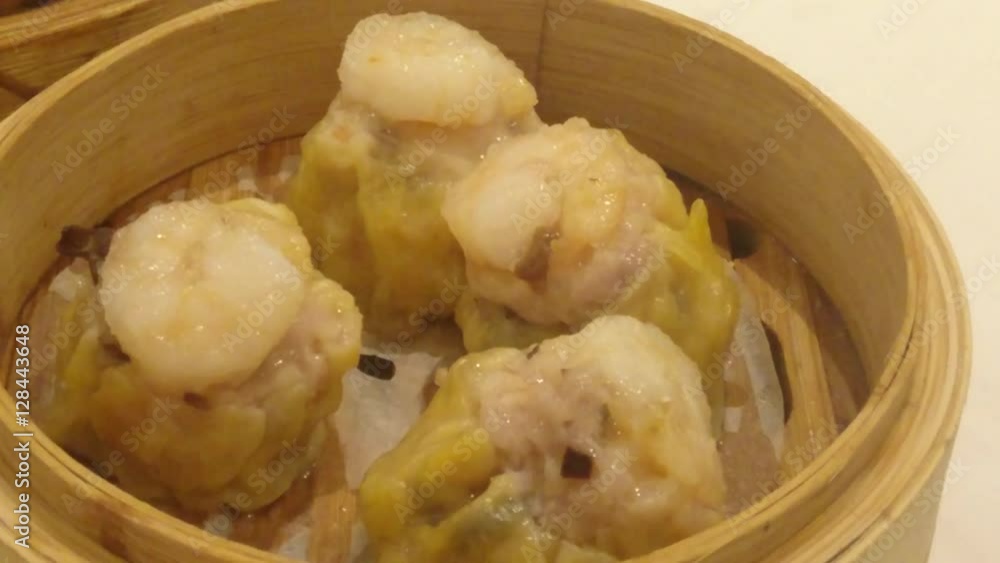 Panning shot of dim sum dishes from shu mai to tripe.