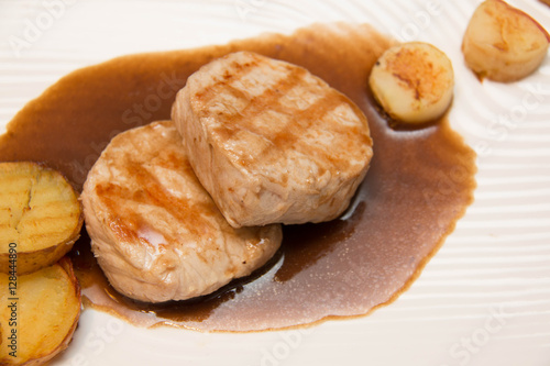 Pork meat grilled with potato  and apple sauce