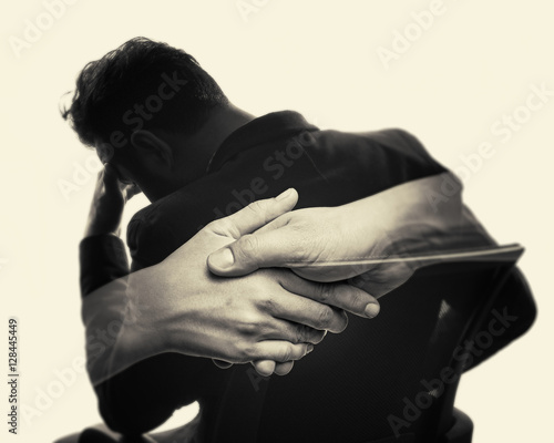 Concept, depicting help. Image created using multiple exposures. Image silhouette of a man in a business suit and a handshake. Black and white