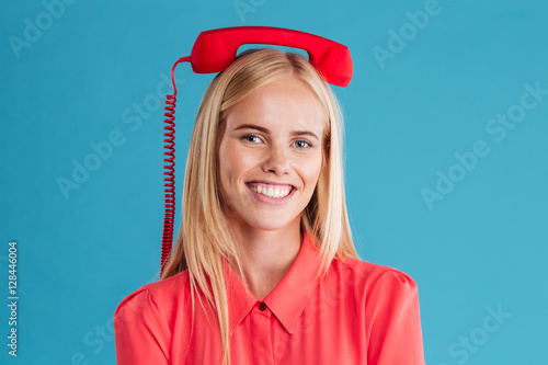 Smiling happy blonde woman with red tube on her head