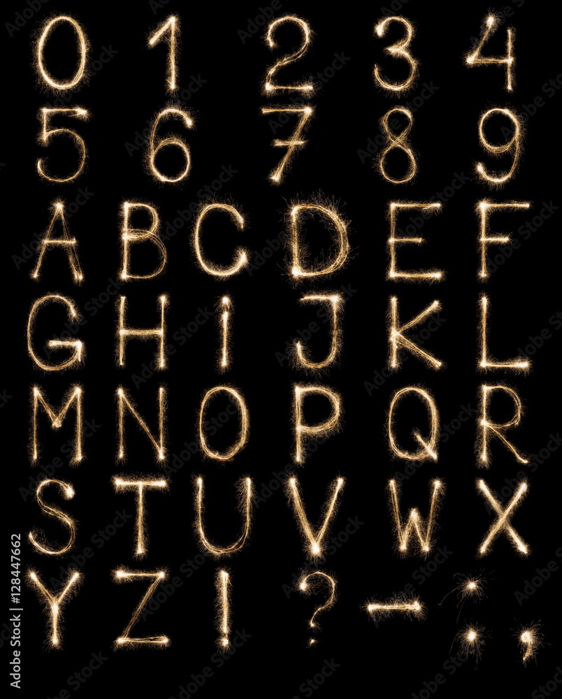English Letters from sparklers, alphabet and numbers on black background.