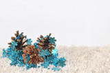Pine Cones and Blur Glitter Christmas Decoration on Light Backgr