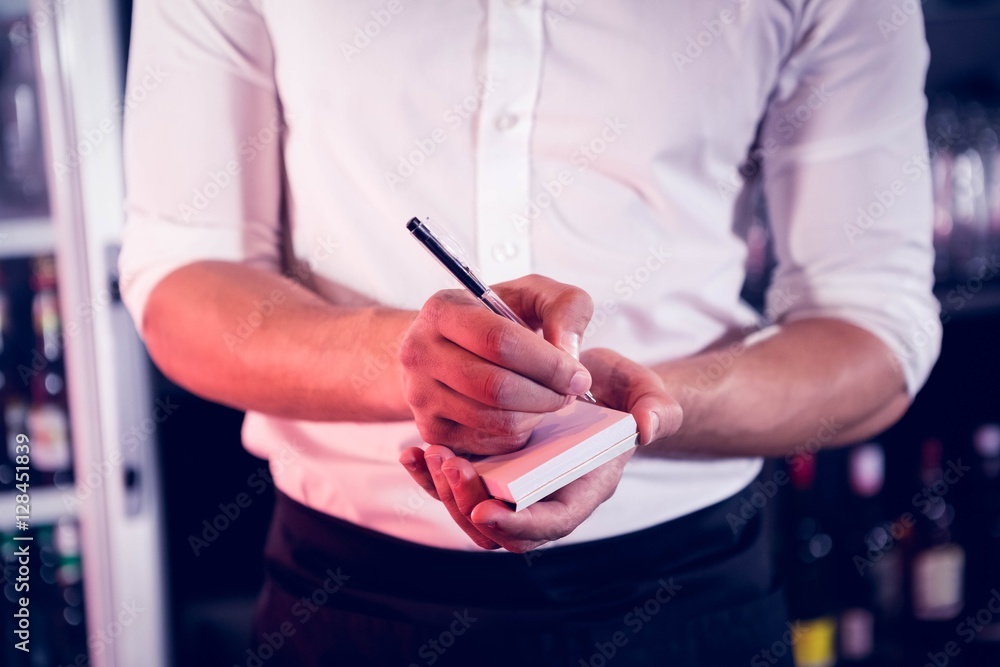 Waiter writing down an order