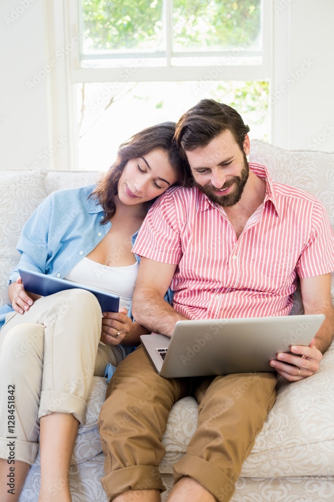 Couple using digital tablet and laptop Couple using digital tablet and laptop
