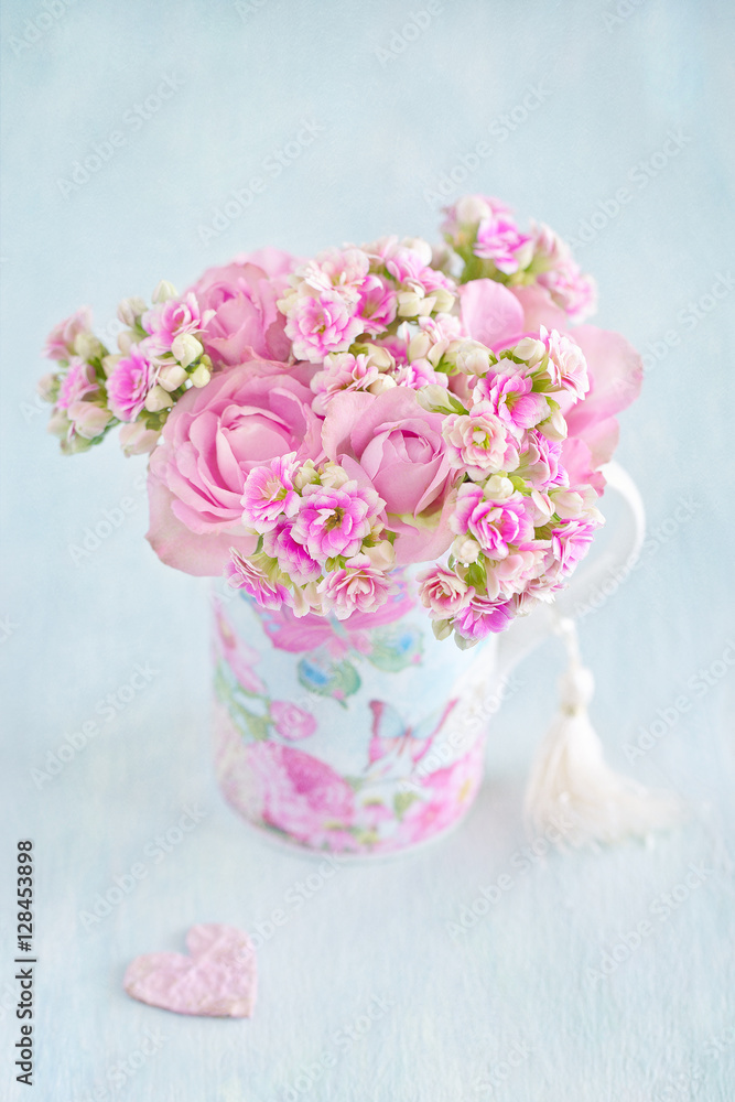 Lovely bunch of a pink flowers in a vase ,decorated with a heart on a table .Vintage style ,grunge paper background. Lovely bunch of a pink flowers in a vase ,decorated with a heart on a table .Vintage style ,grunge paper background.