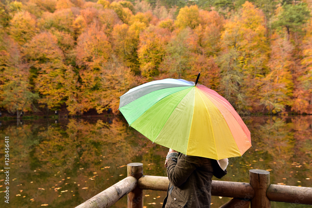 Girl with the colorful umbrella at the Yedigoller National Park, Turkey