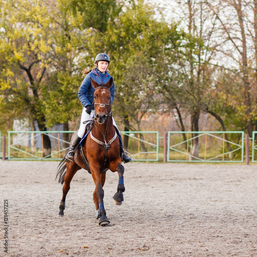 Sportswoman riding horse on equestrian competition