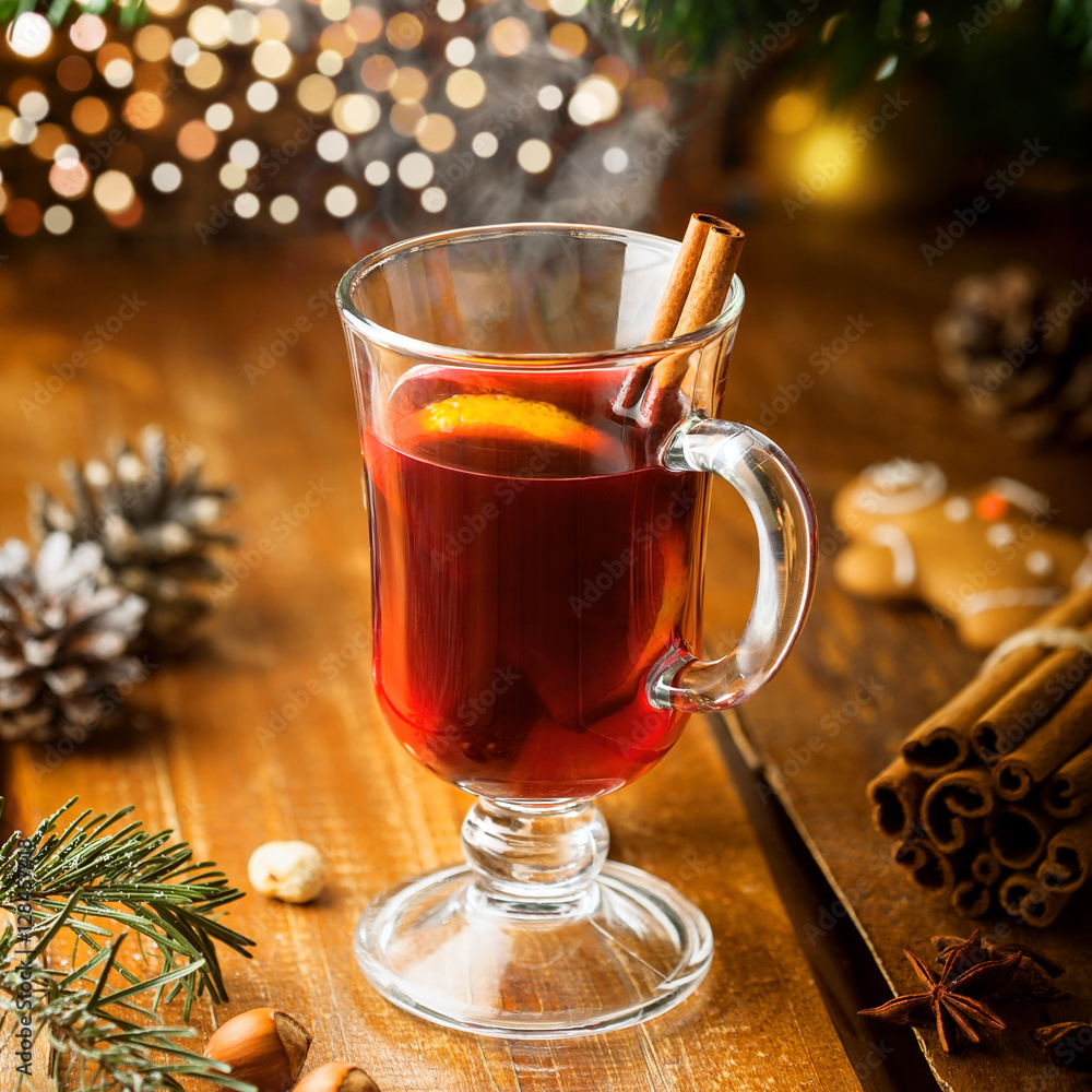 Mulled wine with citrus fruits and cinnamon on a table. Traditional winter hot drink for Christmas Eve party. Mulled wine with citrus fruits and cinnamon on a table. Traditional winter hot drink for Christmas Eve party.