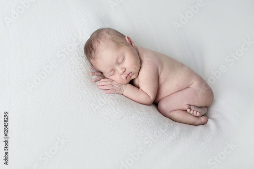 newborn sleeping on stomach light background, real life,  lifestyle,