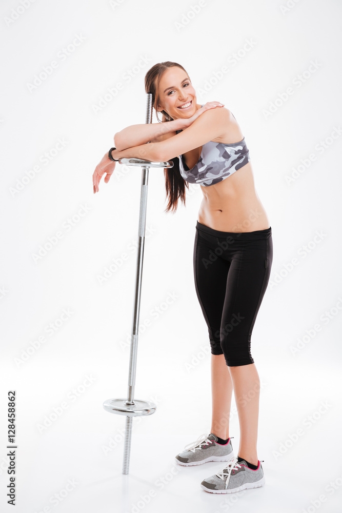 Full length smiling fitness girl with barbell Full length smiling fitness girl with barbell