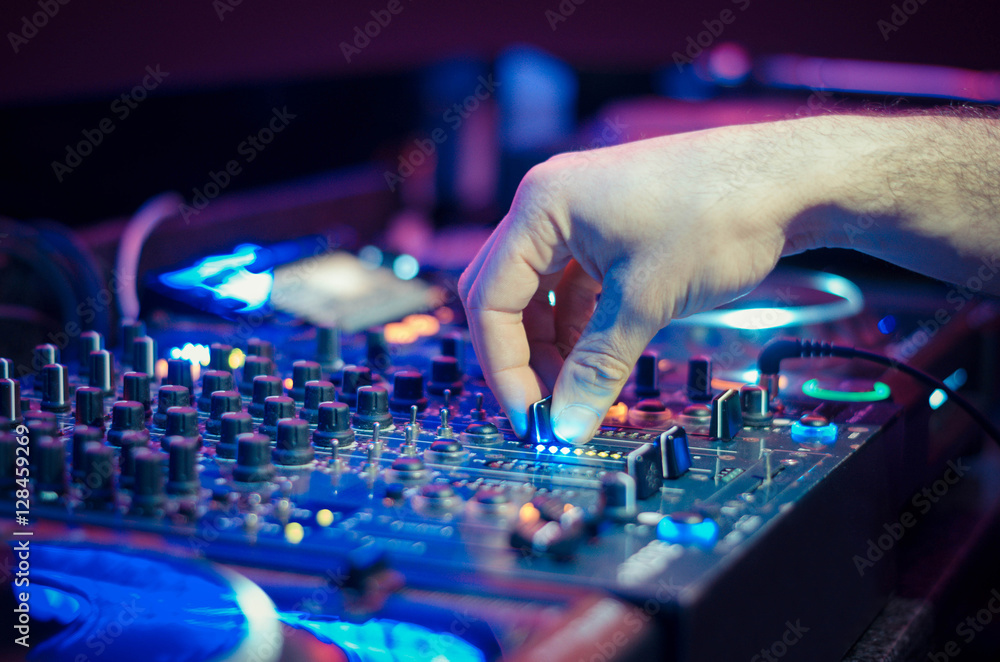 DJ playing music at mixer - obrazy, fototapety, plakaty 