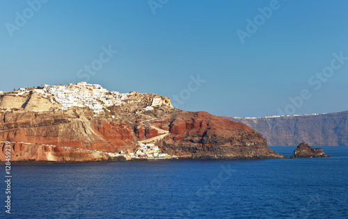 Greece. The volcanic island of Santorini. View from the water at the marina and winding roads to the town of Oia in the evening sun