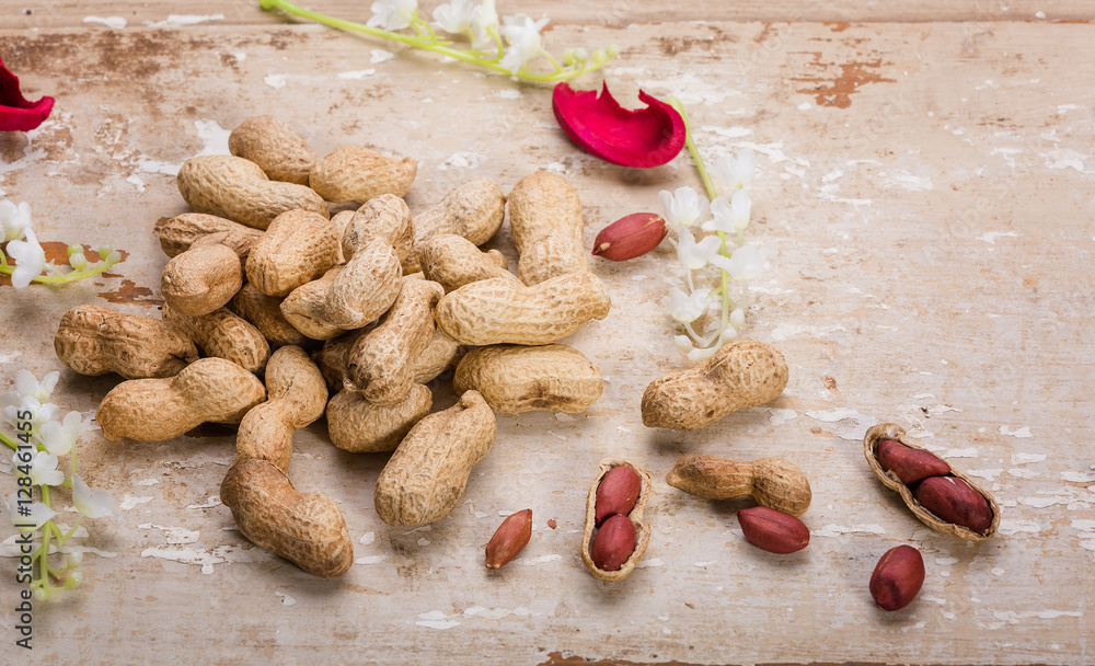Fototapeta premium peanuts on wooden table