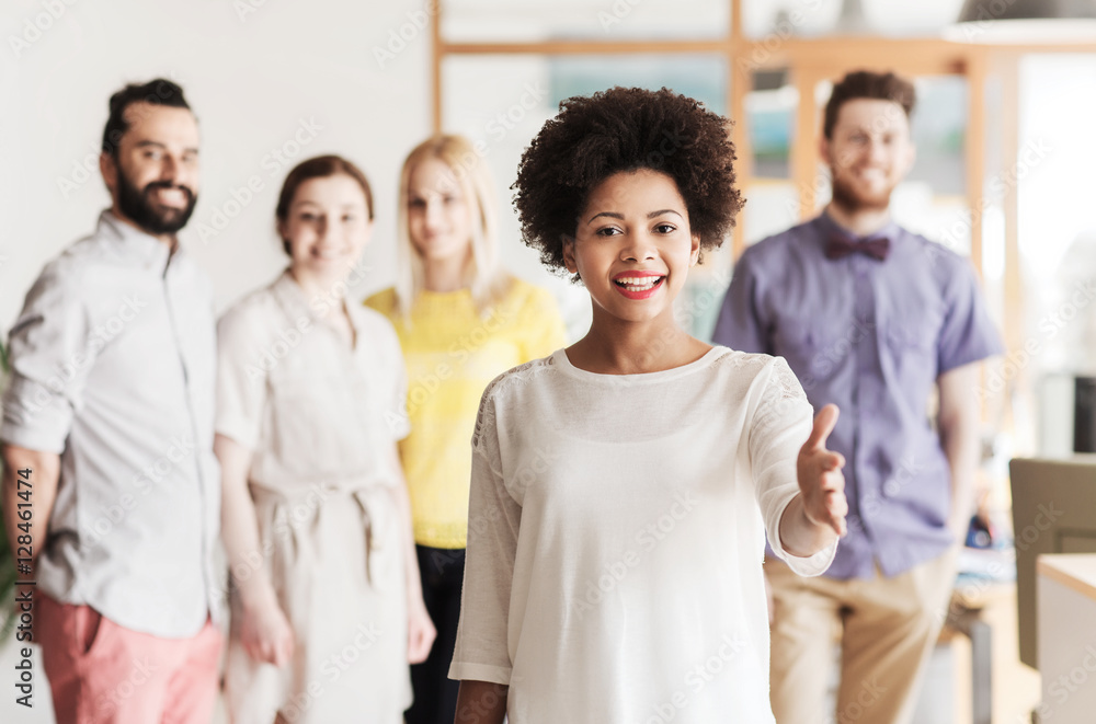 woman making handshake over creative office team woman making handshake over creative office team