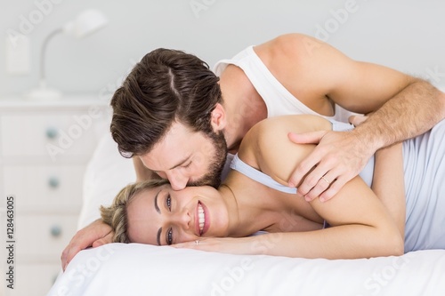 Obraz na plátne Romantic couple embracing on bed