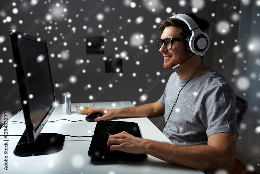 man in headset playing computer video game at home man in headset playing computer video game at home