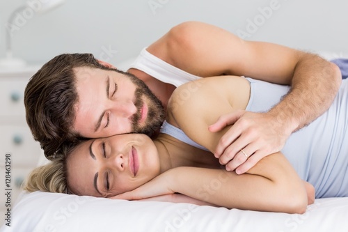 Young couple sleeping on bed