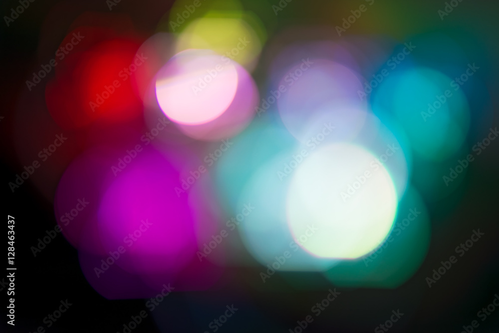Background. Multi-colored lights of a Christmas garland in the background blurring Background. Multi-colored lights of a Christmas garland in the background blurring