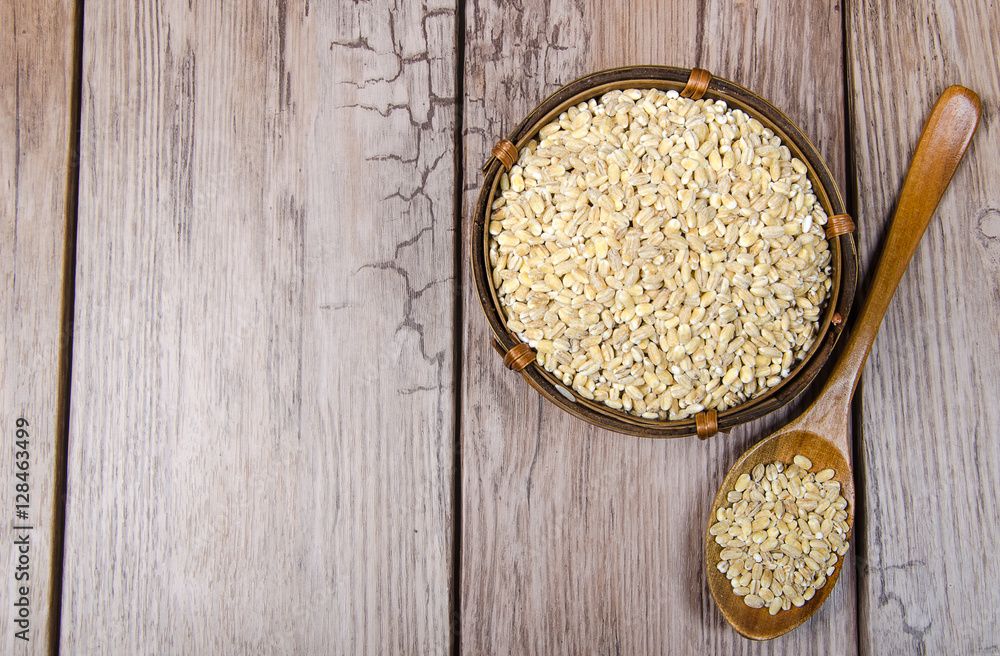pearl barley in wooden bowl pearl barley in wooden bowl