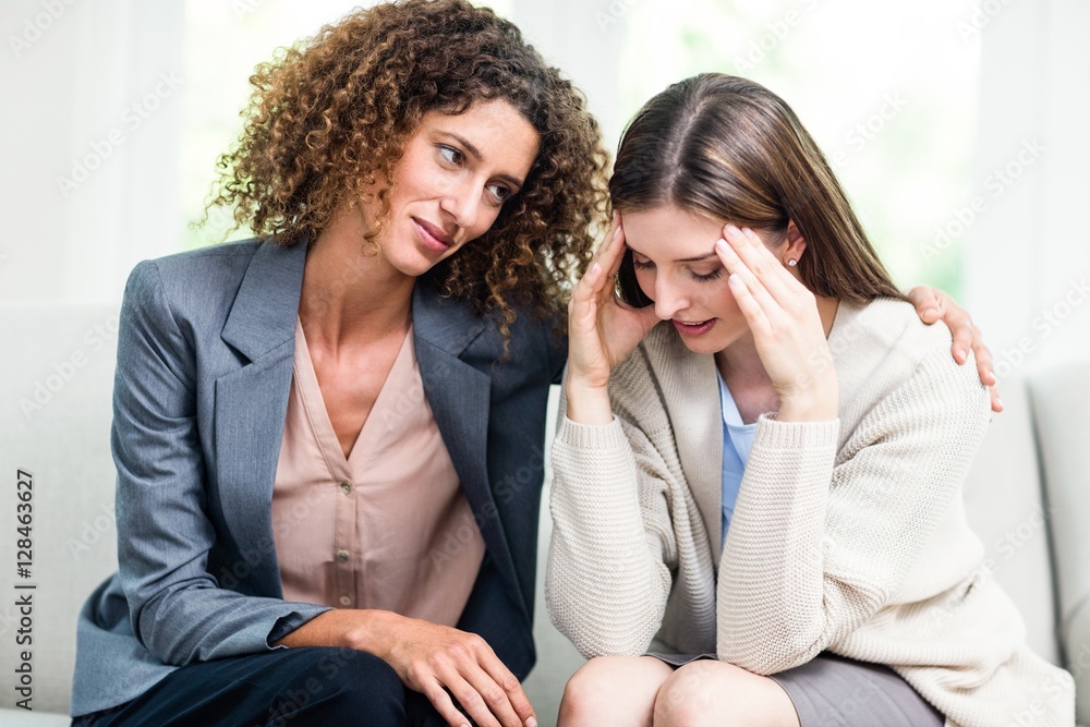 Psychologist counselling depressed woman at home Psychologist counselling depressed woman at home