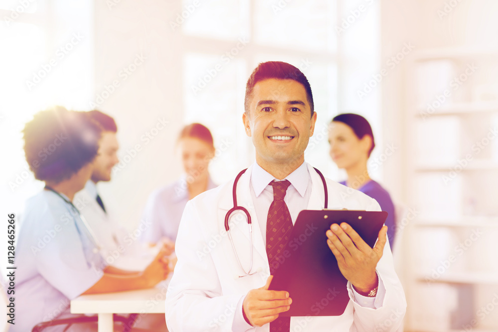 happy doctor with clipboard over medical team happy doctor with clipboard over medical team