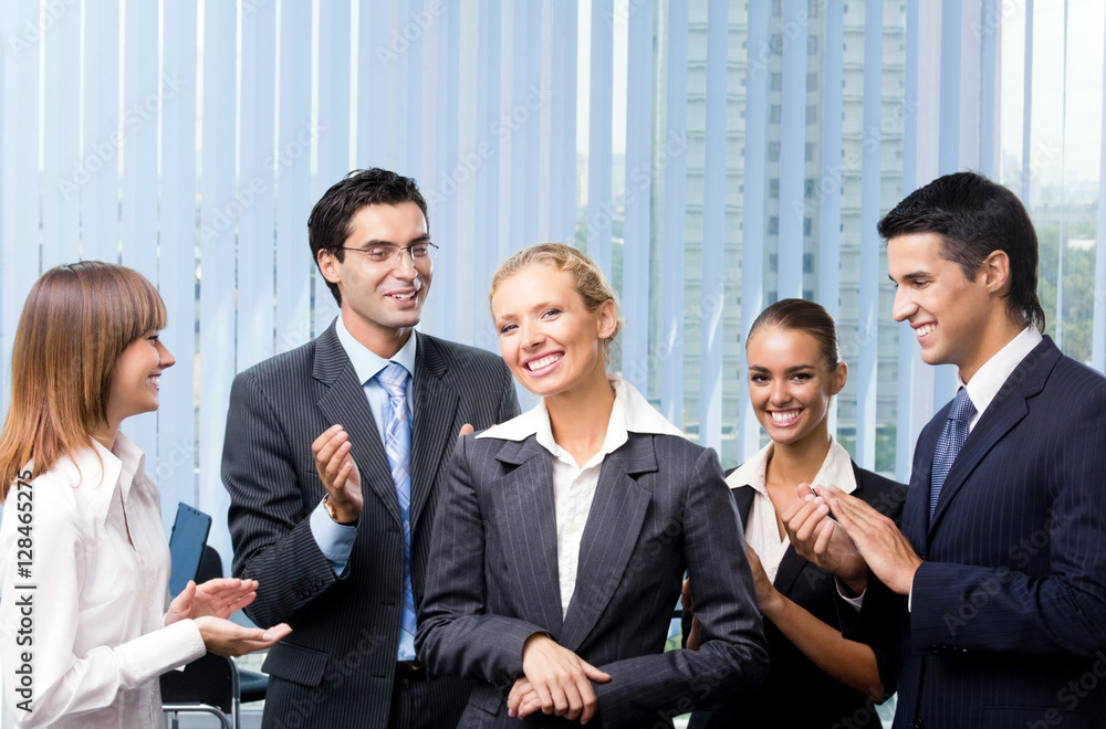 happy businesswoman and businessteam at office happy businesswoman and businessteam at office