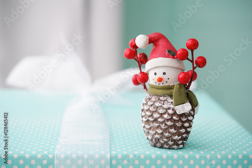 toy snowman on turquoise background, Christmas gifts