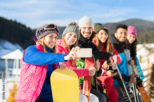 People Group With Snowboard And Ski Resort Snow Winter Mountain Cheerful Taking Selfie Photo Friends Hands Having Fun © mast3r