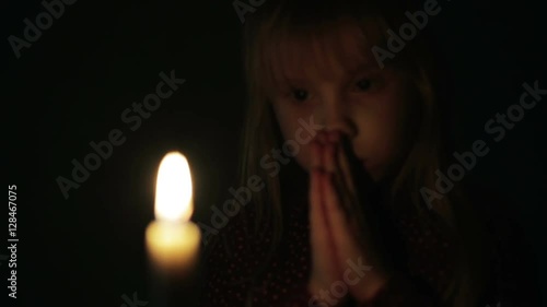 Portrait of a small girl with a candle.