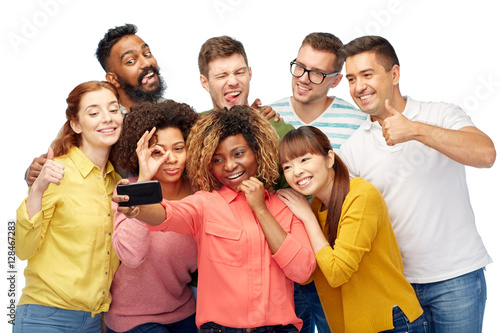 group of people taking selfie by smartphone