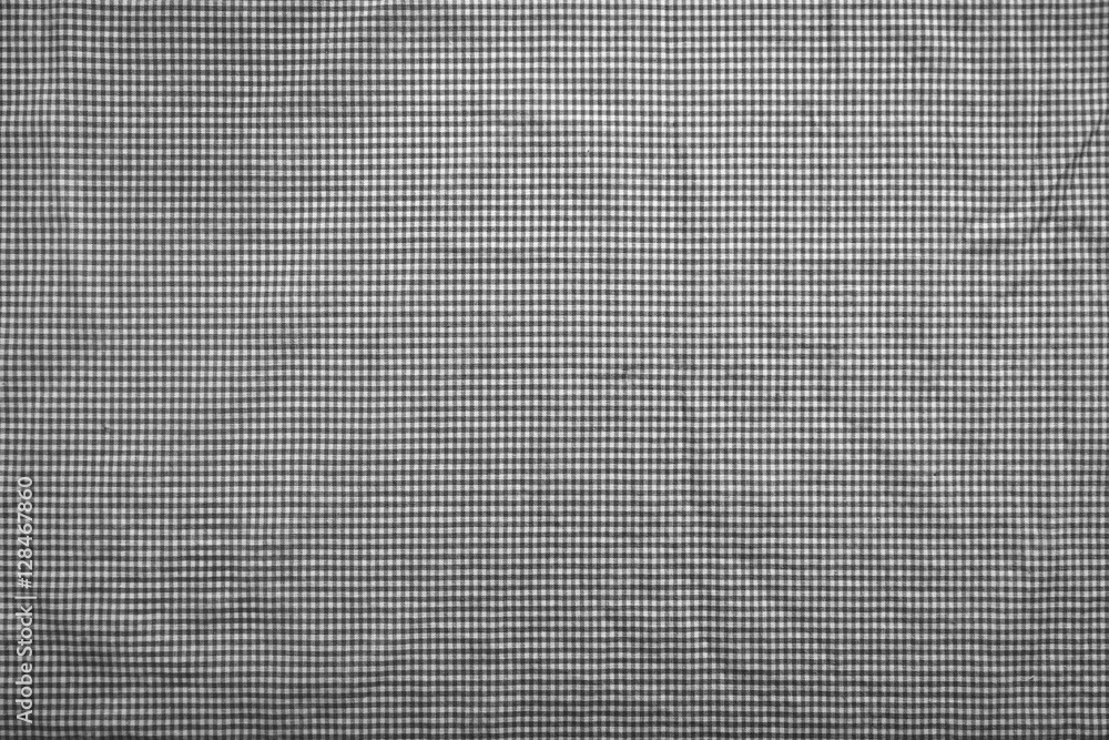 Background shot of a slightly wrinkled black and white gingham checkered tablecloth Background shot of a slightly wrinkled black and white gingham checkered tablecloth