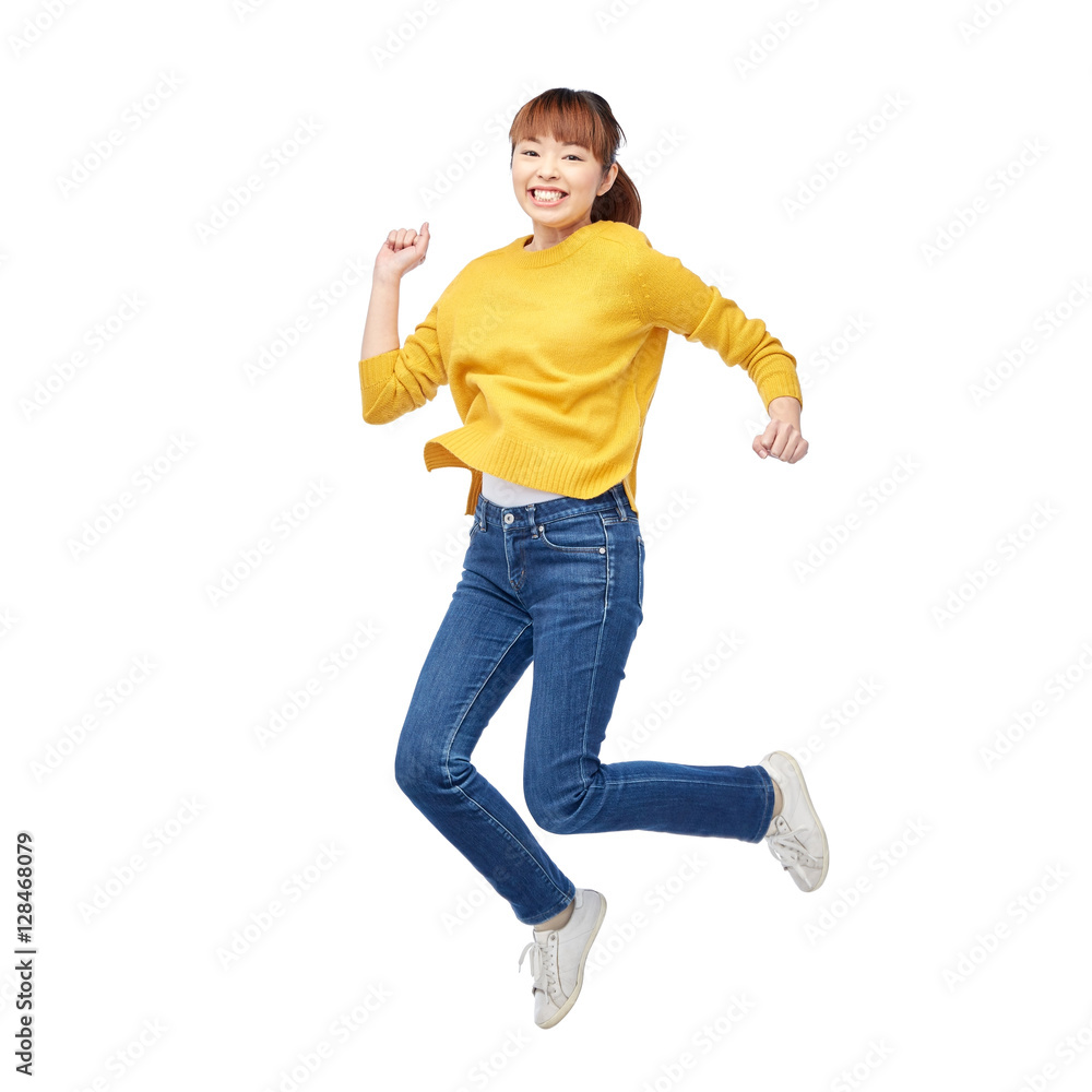 Naklejka premium happy asian woman jumping over white