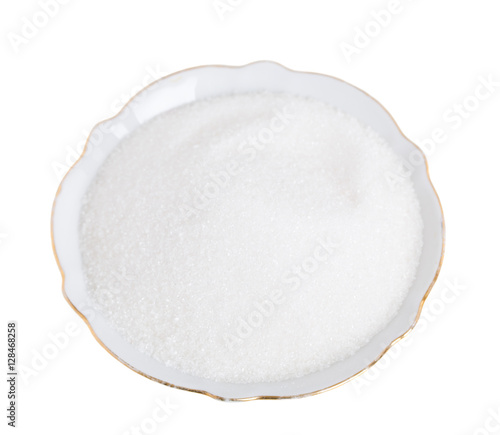 Closeup of sugar in white bowl.