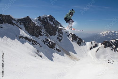 Ski rider jumping on mountains. Extreme ski freeride sport.