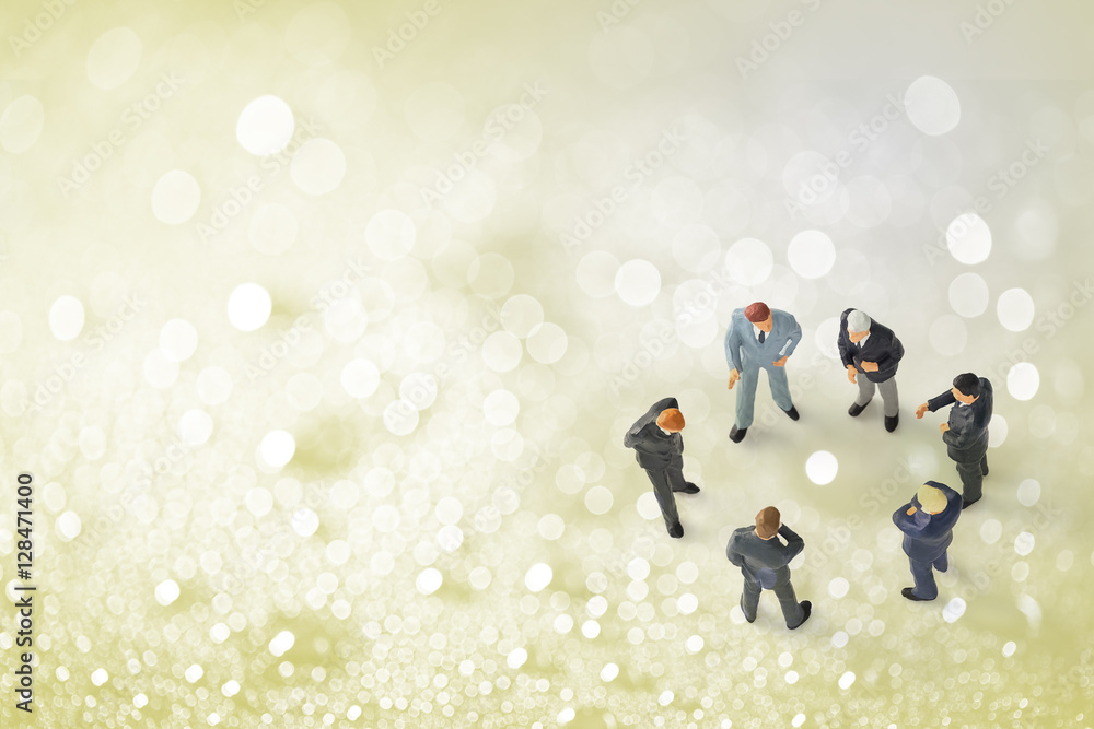 Fototapeta premium miniature businessmen on water drops bokeh background