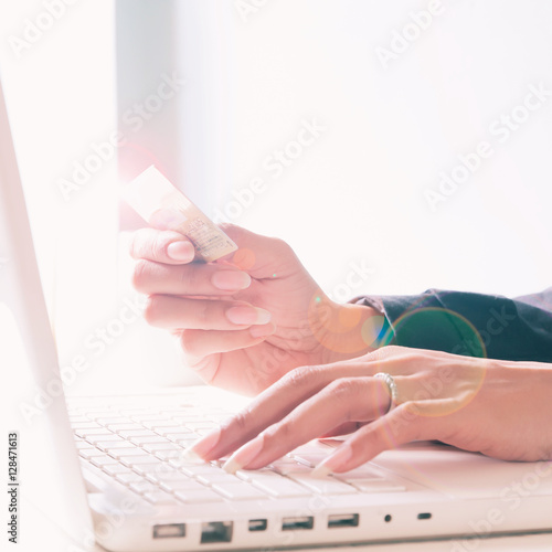 Hands holding credit card and using laptop. Online shopping with copy space